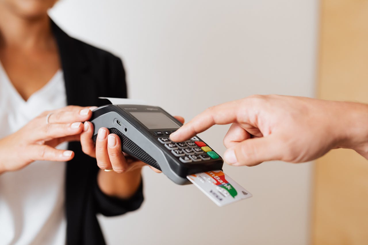 A customer using a contactless payment terminal for secure and cashless transactions indoors.